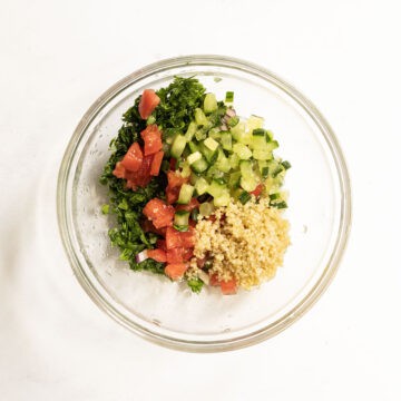 Tabbouleh ingredients mixed together in a bowl.