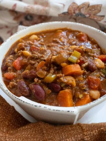 A bowl of chili with a spoon.