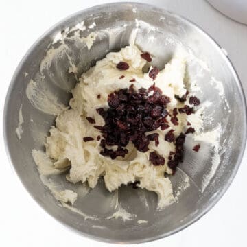 folding in dried cranberries into cookie dough.