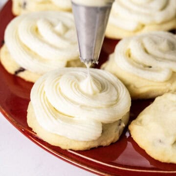 Cookies being frosted with a piping bag.