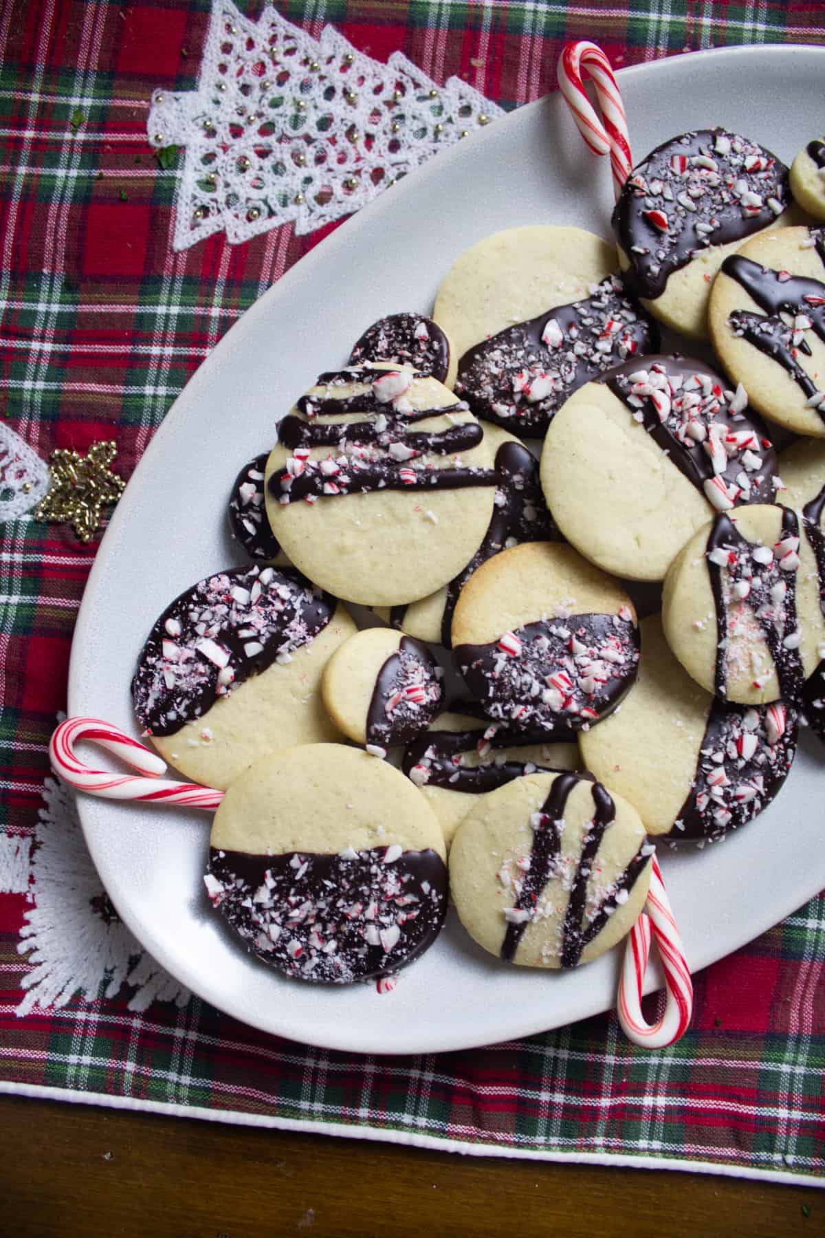 dark chocolate half dipped sugar cookies with candy cane crumbles