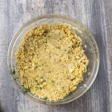 Clams combined with breadcrumb mixture in a bowl.
