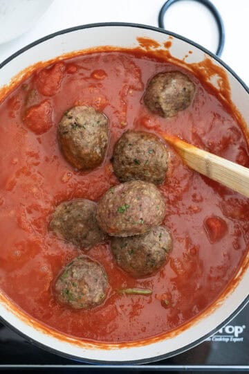 Meatballs added to tomato sauce.