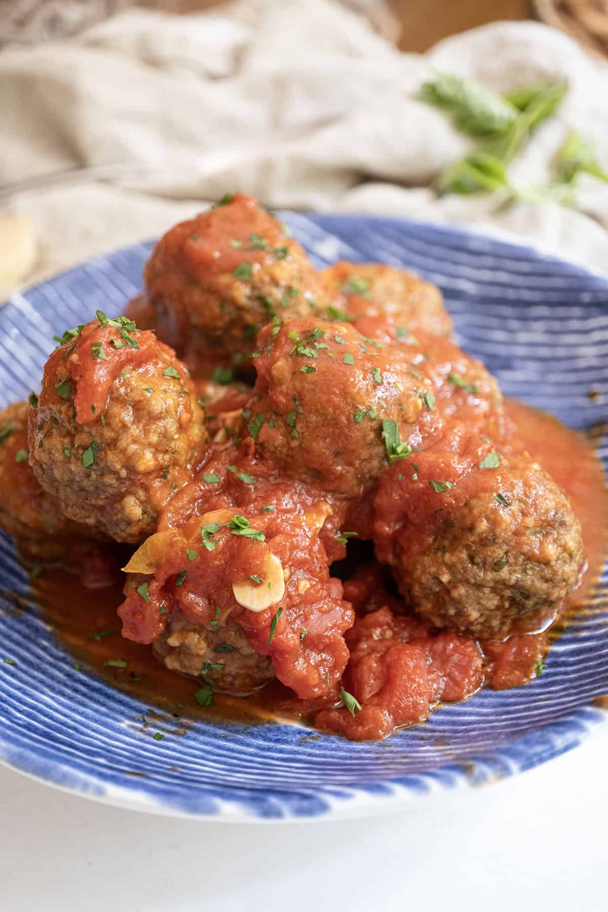 Meatballs covered in tomato sauce in a bowl.