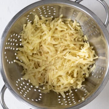 Rinsing the potatoes in colander.