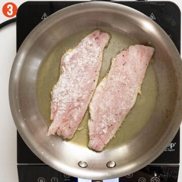 Searing snapper skin side down in a pan.