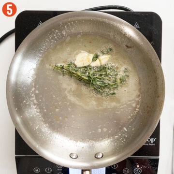Sauteing garlic and thyme in butter.