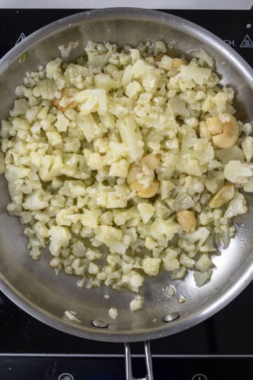 cauliflower added to saute pan with garlic.