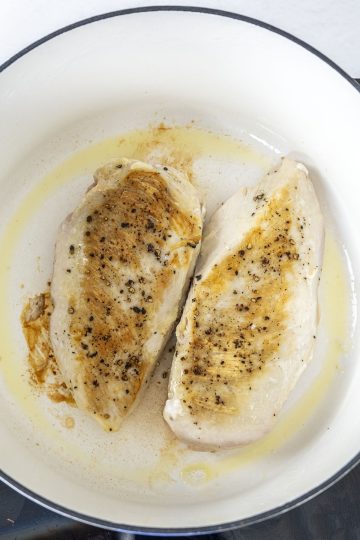 Searing chicken breast until golden brown