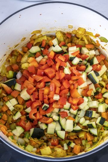 Red pepper and zucchini added to saute