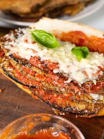 Eggplant topped with marinara, parmesan, and mozzarella on a roll.