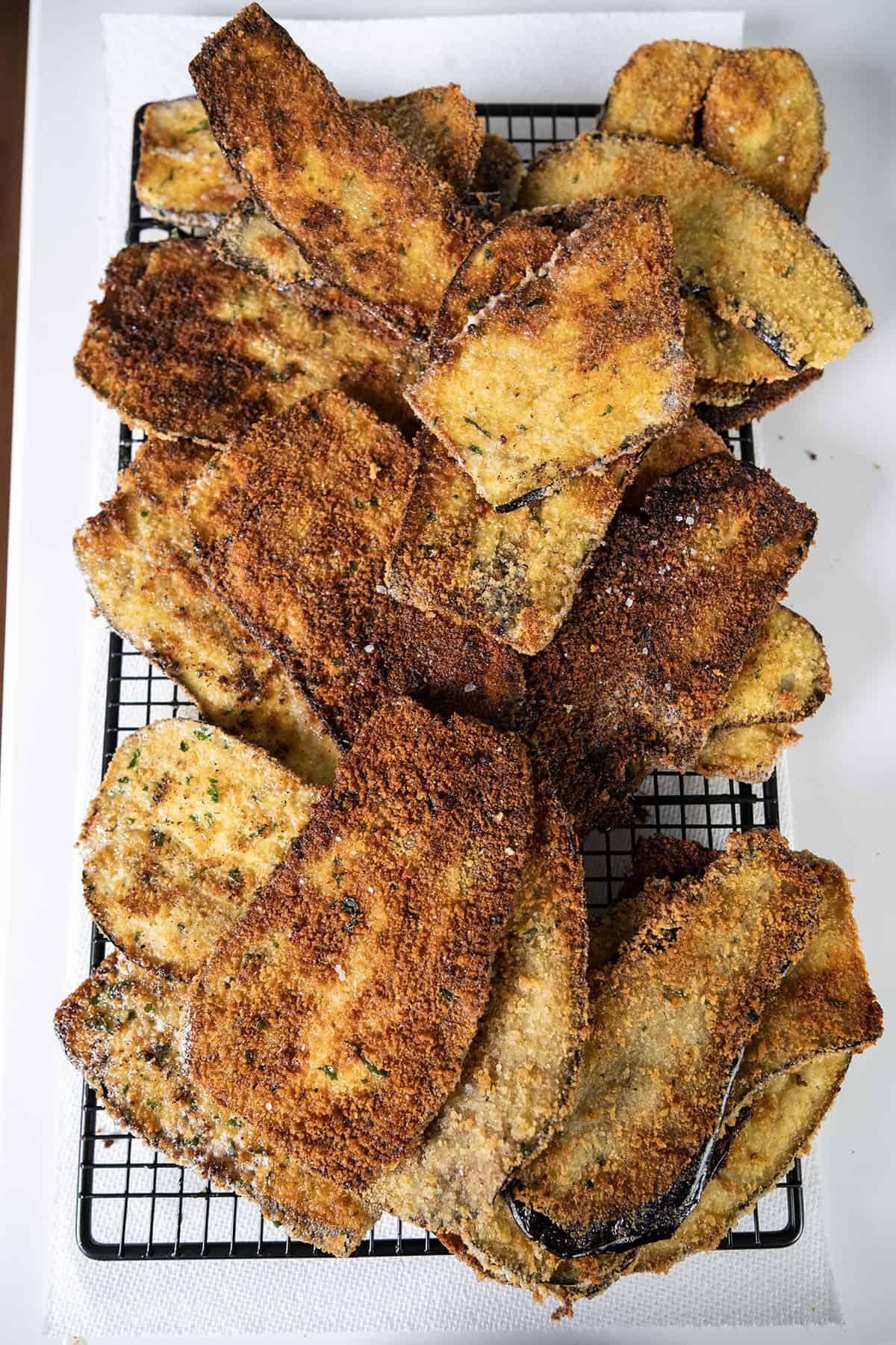 Fried eggplant on a cooling rack.