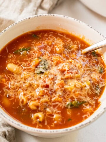 Pasta fagiolo topped with parmesan in a bowl.