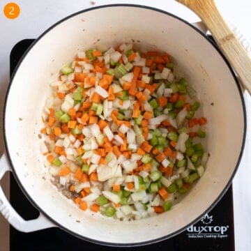 Sauteing carrots, celery, and onion in dutch oven.