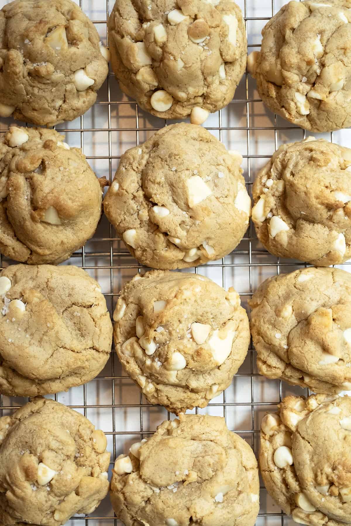 White chocolate macadamia nut cookies on a cooling rack.