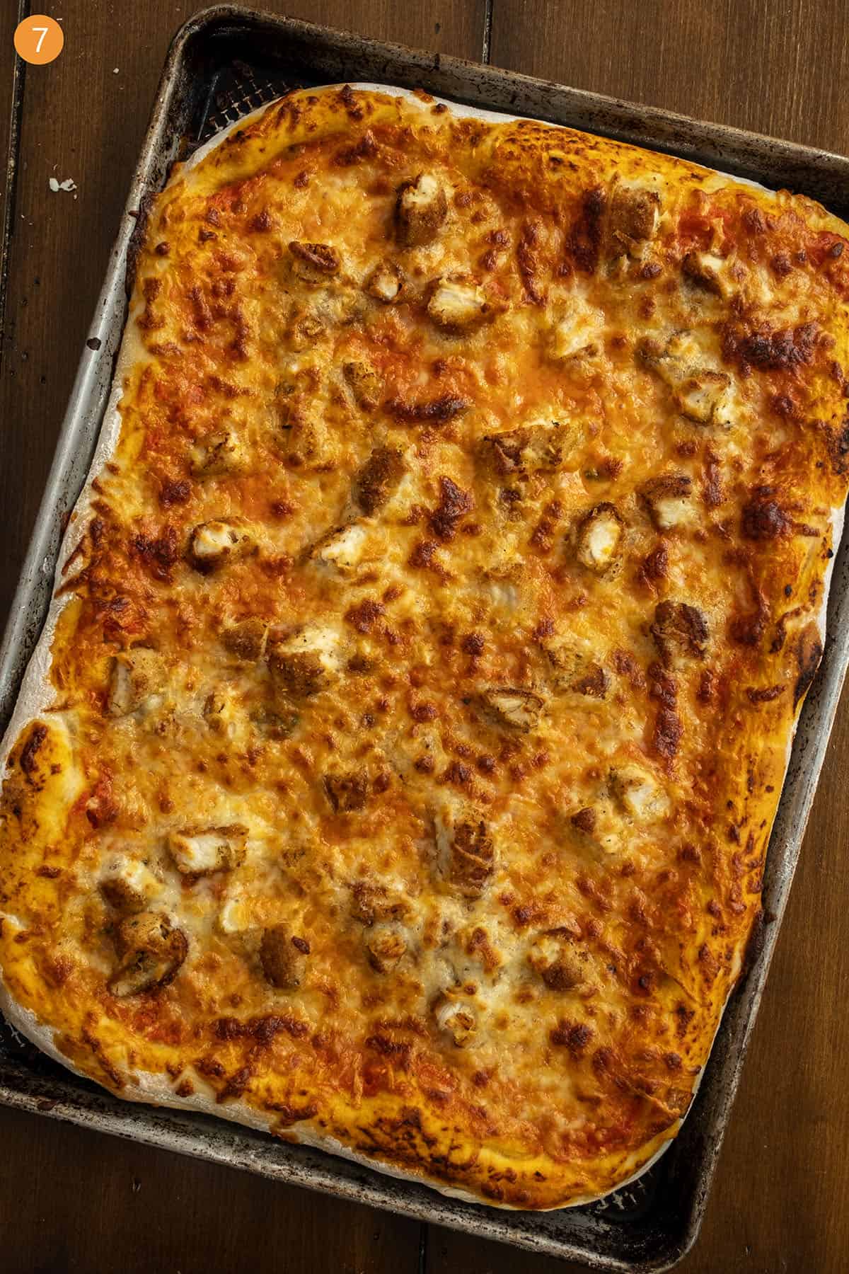 Pizza cooked on a cutting board.