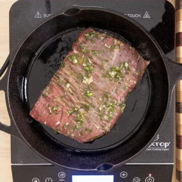 Searing steak on cast iron pan.