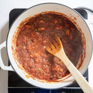 Simmering crushed tomatoes with vegetables.