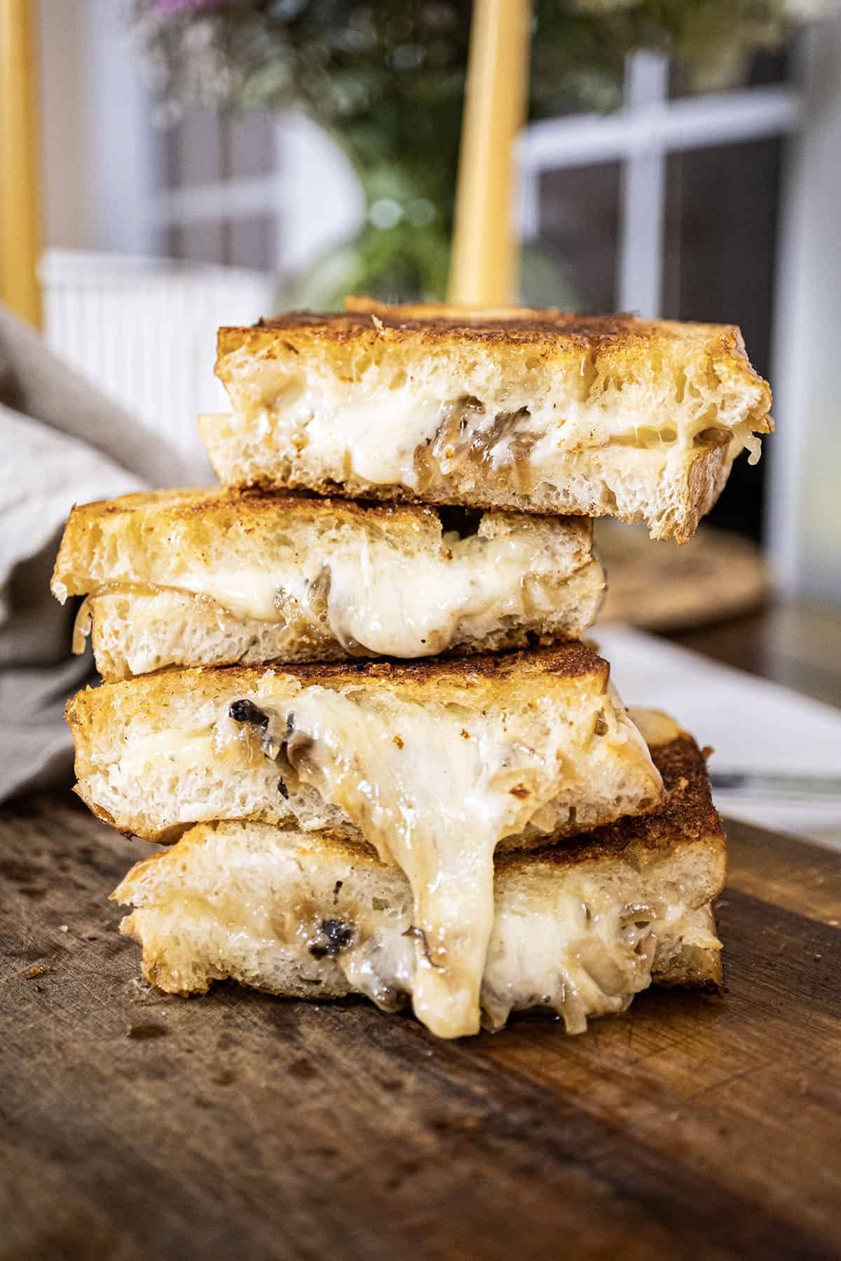 4 halves of the grilled cheese stacked on top of one another.