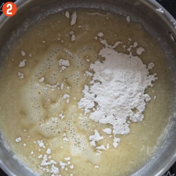 Combining butter and flour to form a roux.
