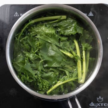 Blanching the broccoli rabe.