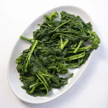 Boiled broccoli rabe on a plate.