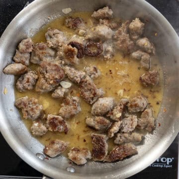 White wine added to the sauce in the pan.