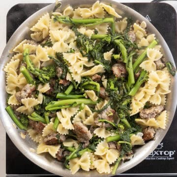 Farfalle added to the pan with broccoli rabe and sausage.