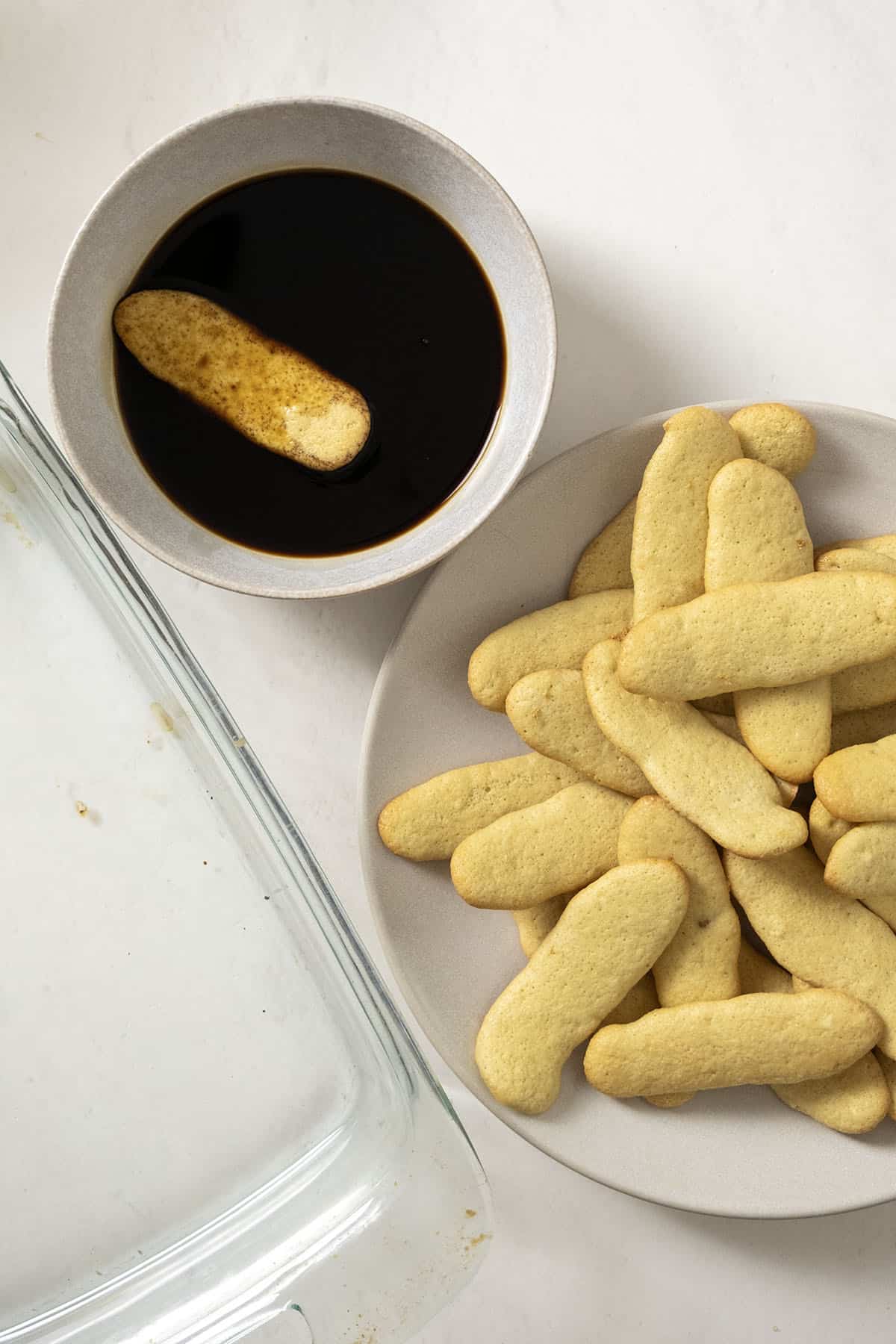Dipping ladyfingers into espresso and Disaronno mixture.