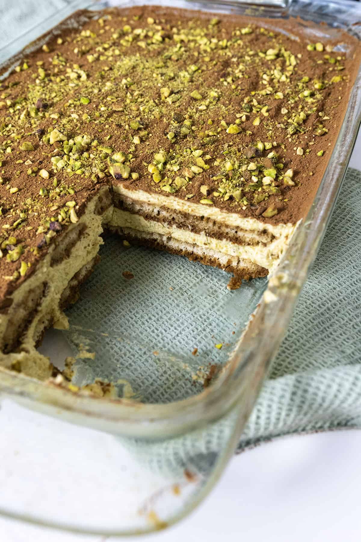 The tray of tiramisu with a square cut out.