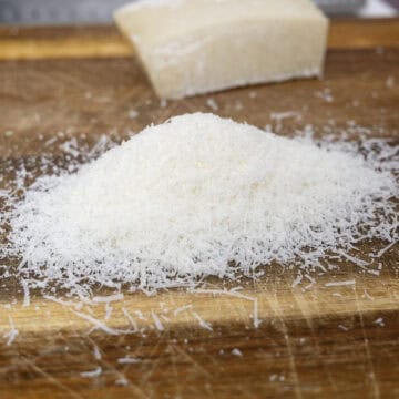 Pecorino grated on a cutting board.