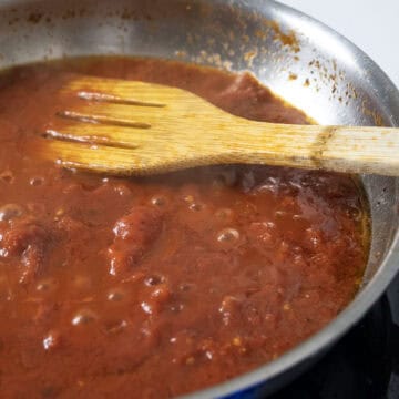 Black pepper added to the sauce and simmering.