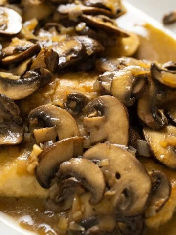 Chicken marsala with mushrooms served over top.