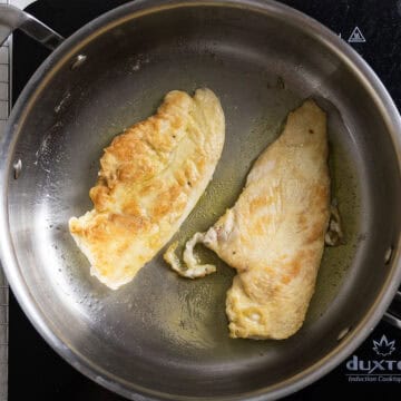Frying chicken breasts in the pan in olive oil.