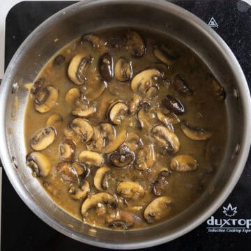 Chicken removed from the sauce for sauce to simmer and thicken.