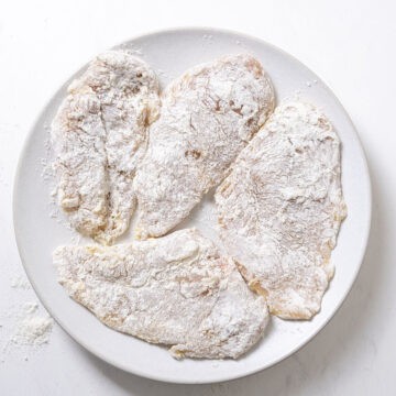 Chicken breasts dredged in flour.