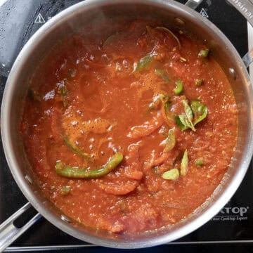 Sauce added to peppers, simmering.