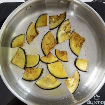 Frying eggplant in a sauce pan.