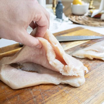 Chicken breast butterflied in thirds.