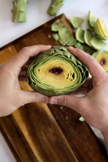 cutting off top of artichoke