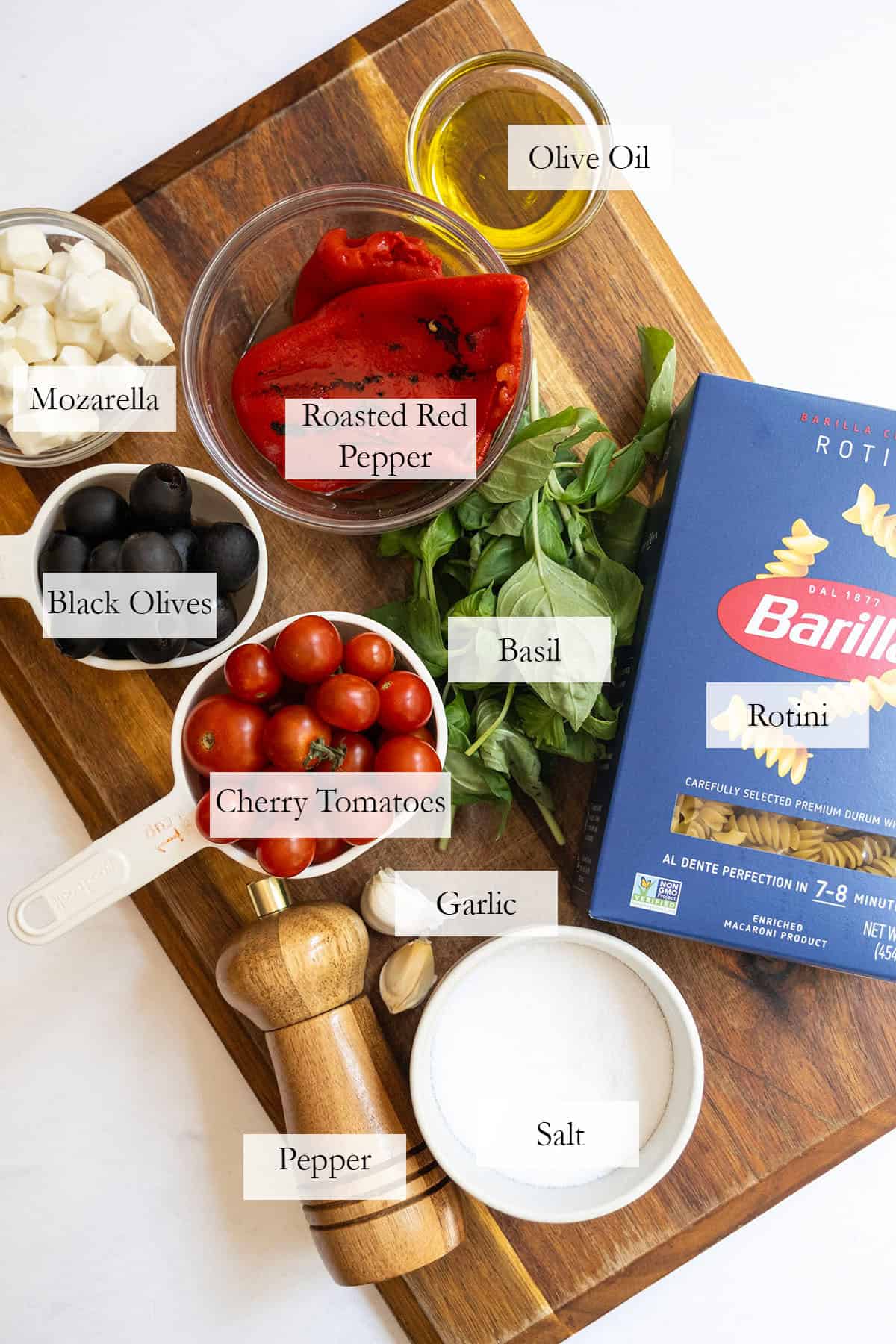 ingredients for the pasta salad on a cutting board.