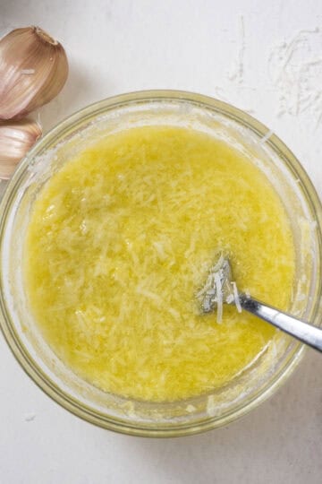 Pecorino lemon juice mix in a bowl whisked with a fork.