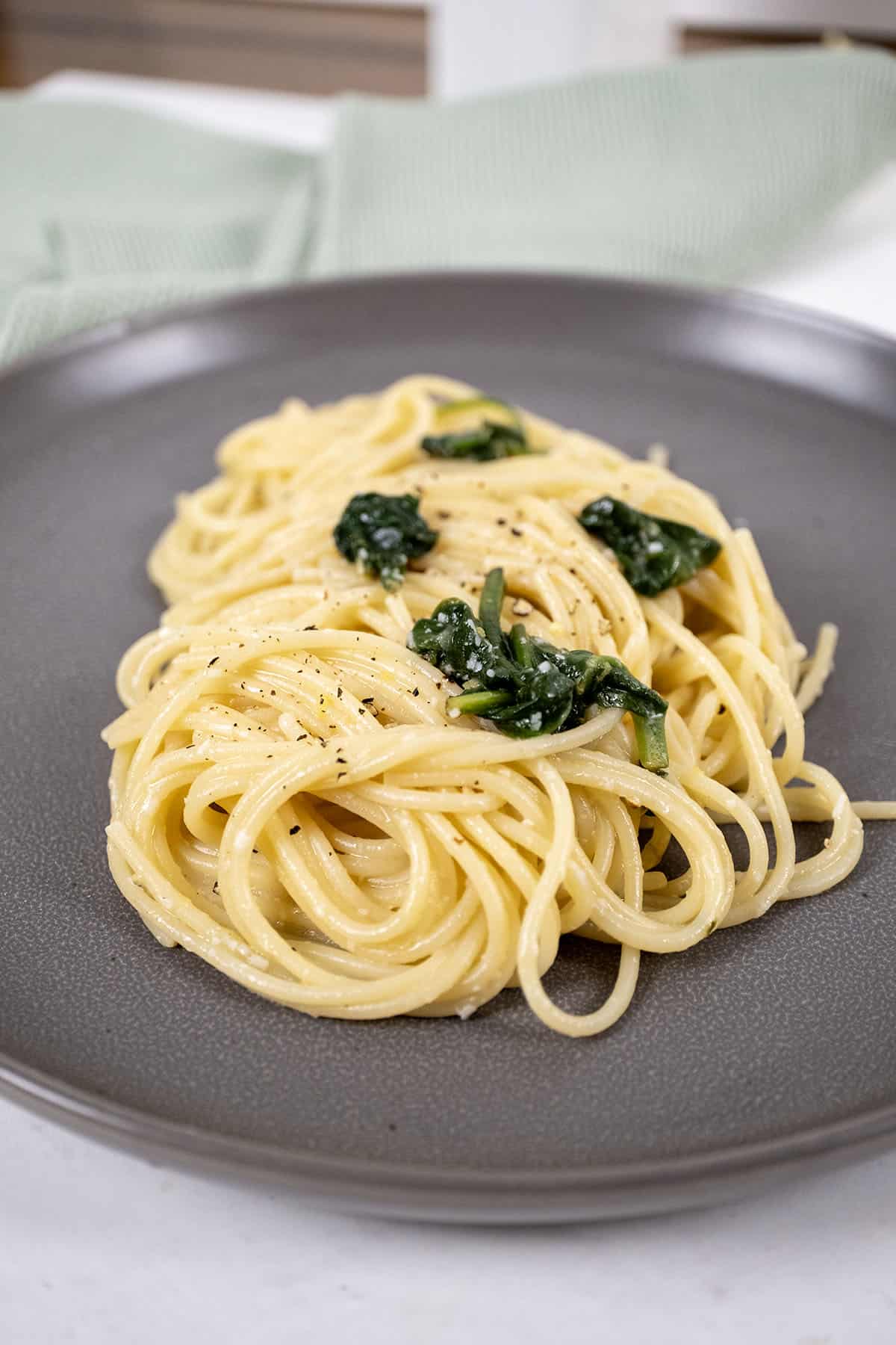 Lemon spinach pasta served on a plate.