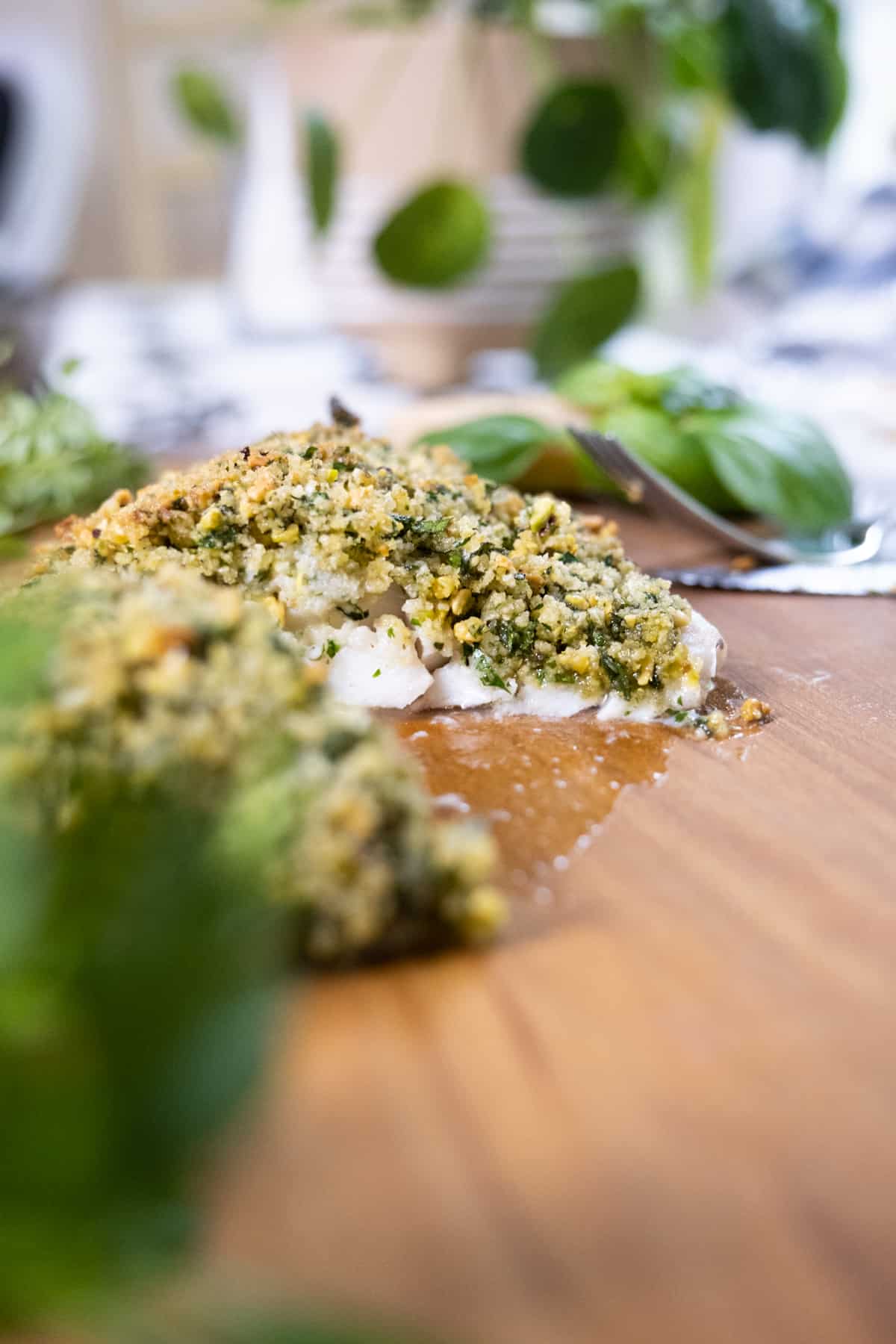 Pistachio crusted sea bass on a plate.