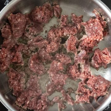 Lamb searing in saucepan.