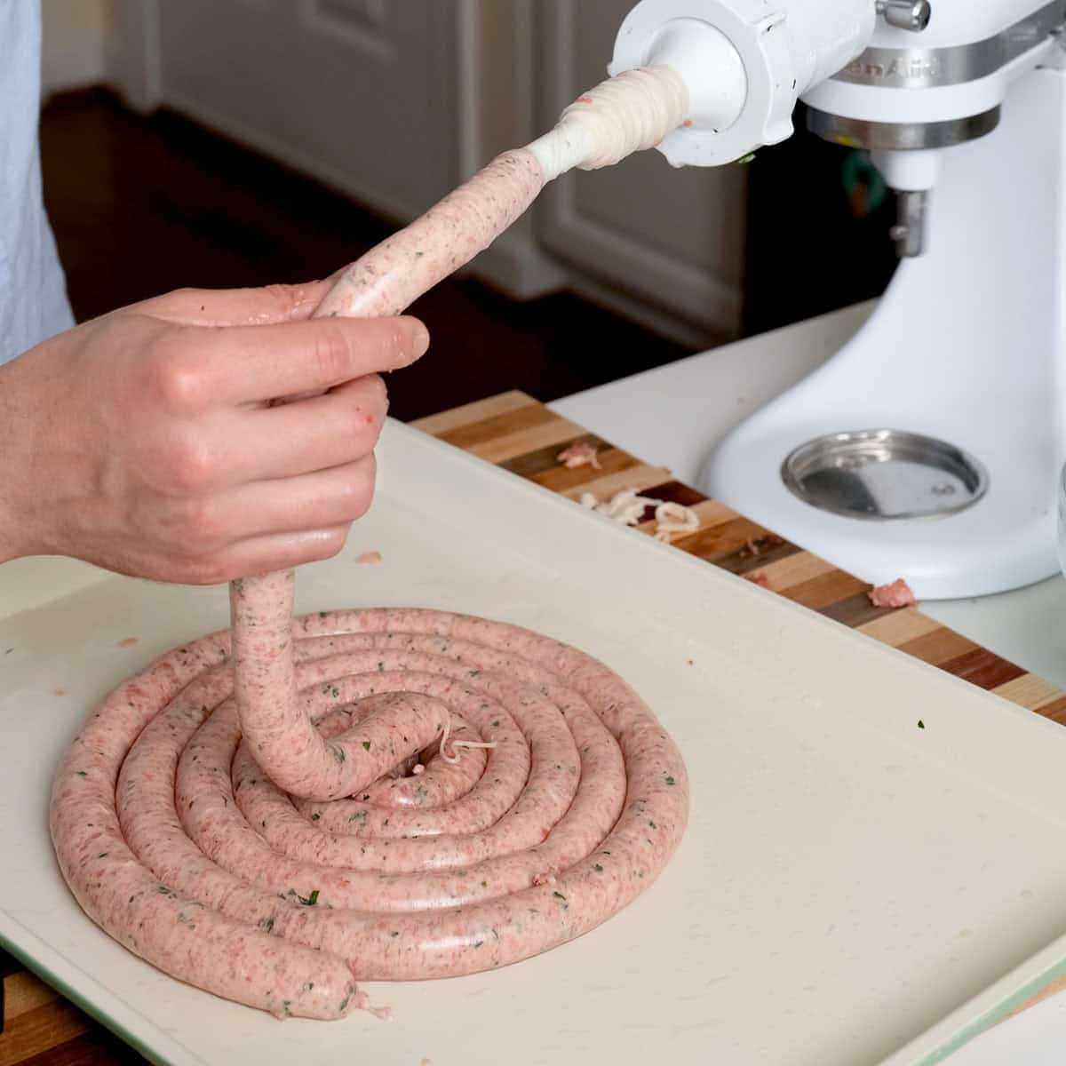 Vinny stuffing the sheep casings with sausage.