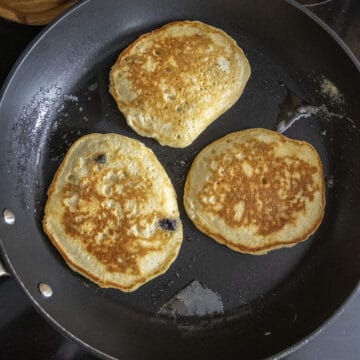 Pancakes flipped over on the frying pan.