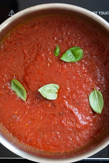 Basil ad tomatoes added to sauce.