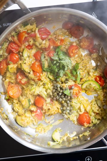 capers and basil added to sauce