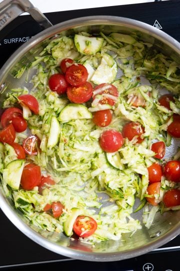 zucchini and cherry tomatoes stirred into oil